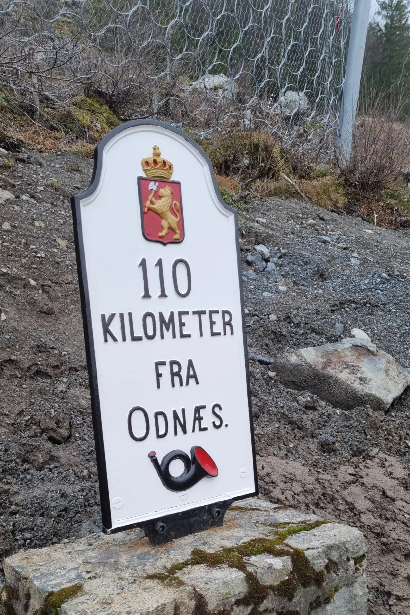 110 kilometre plaque on the ground